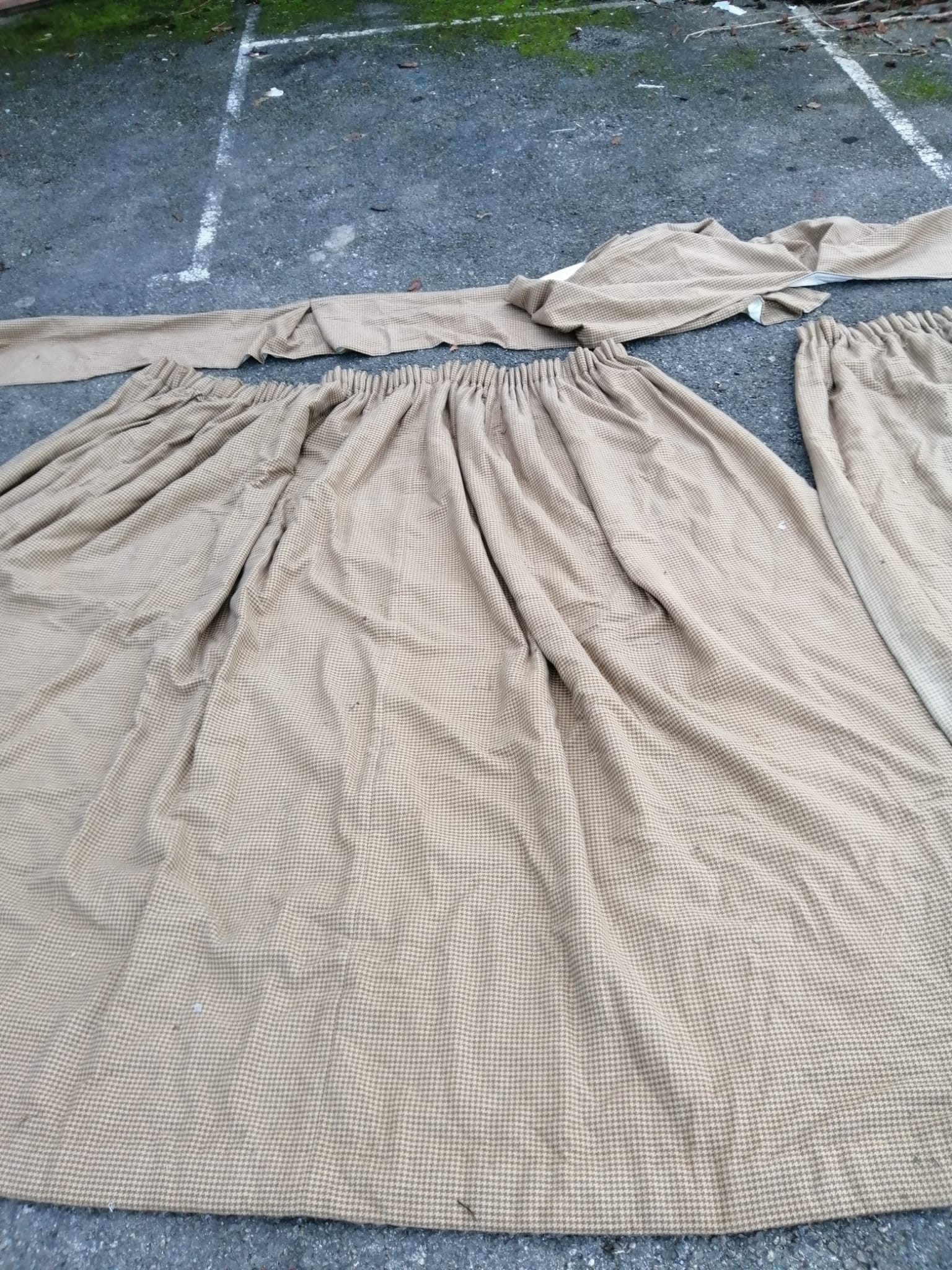 A pair of tweed curtains and two matching single curtains with a spare roll of material.